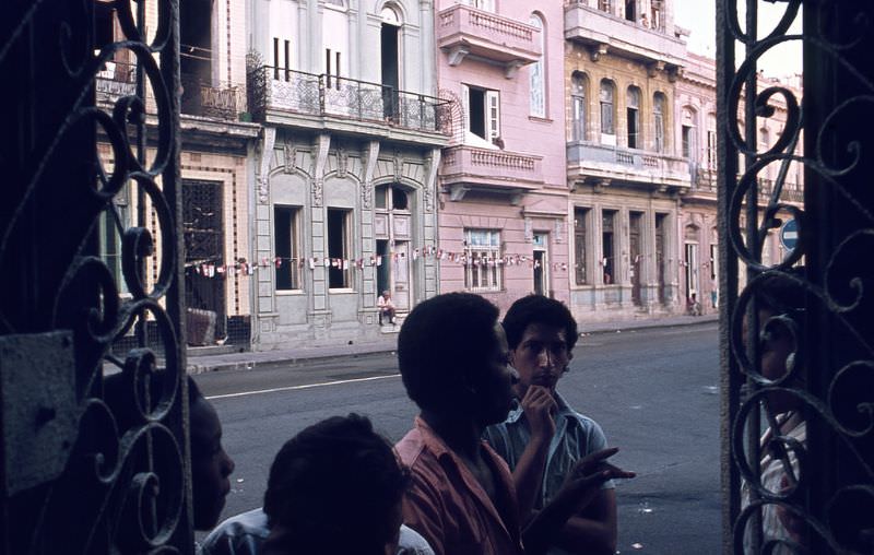 Lattice of a house and boys talking in the neighborhood of the ancient Havana, Santa Clara, 1970s