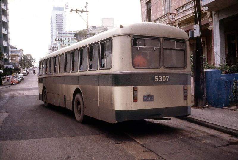 An unwashed public transport bus pulls away from a stop near the Plaza de la Revolucion, Havana.