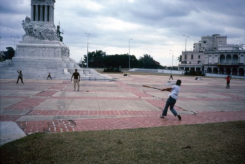 A group of boys play baseball on the plaza near the Monument To Maximo Gomez, Havana.