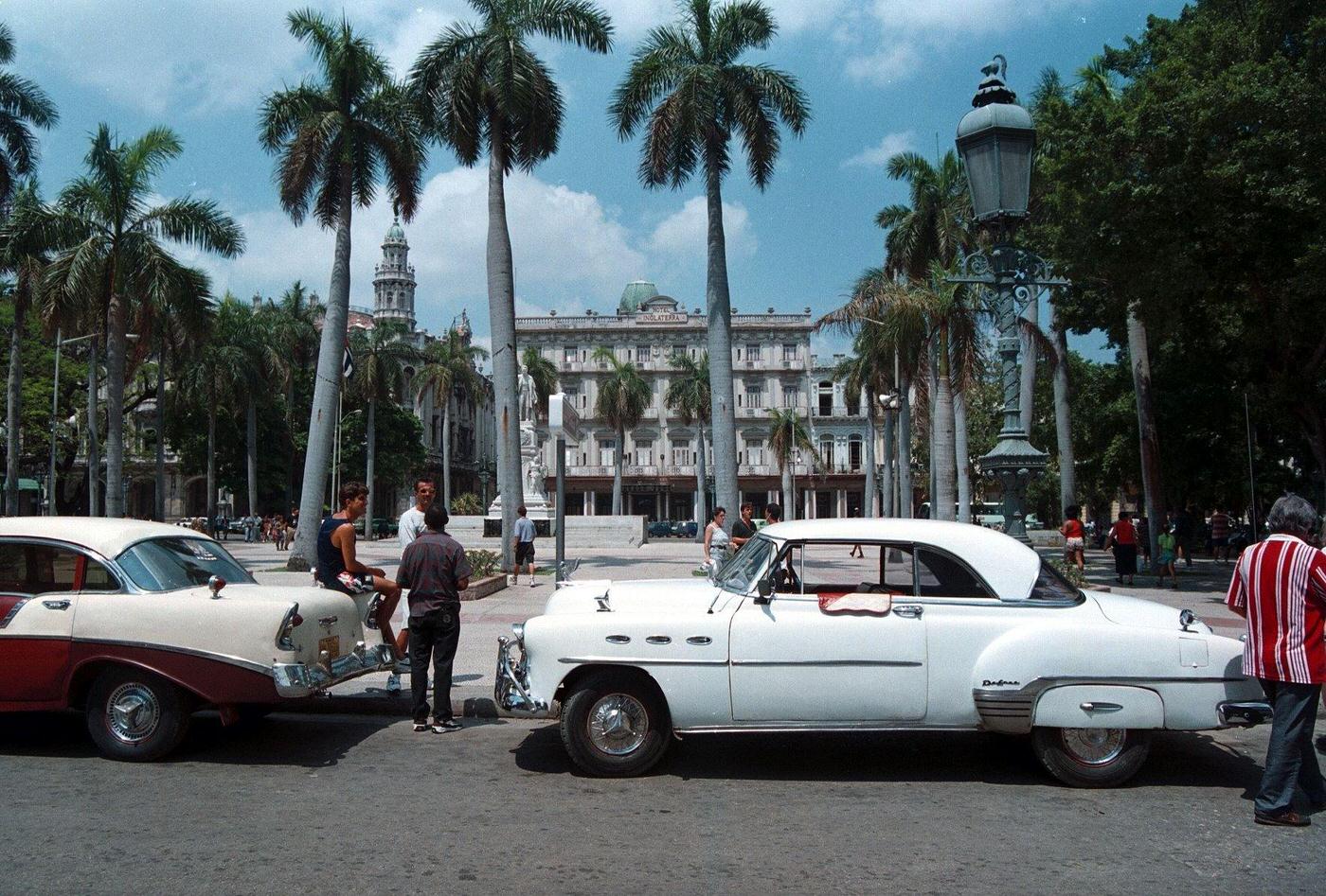 Colonial Hotel "Inglaterra" with old cars and palm trees in Havana, Cuba.