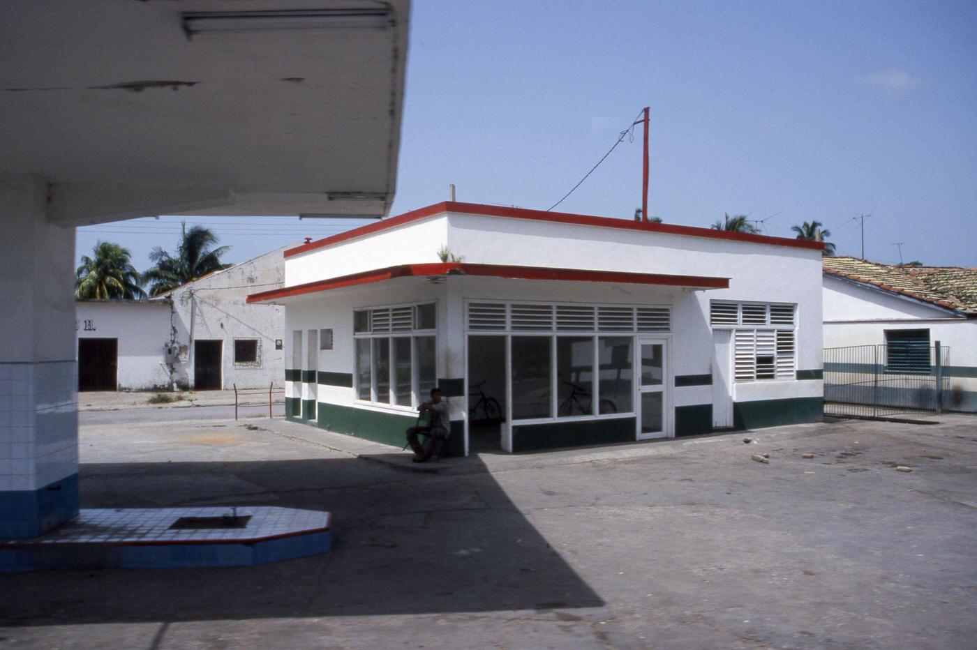 Abandoned gas station and a man in Matanzas, Cuba, June 1999.