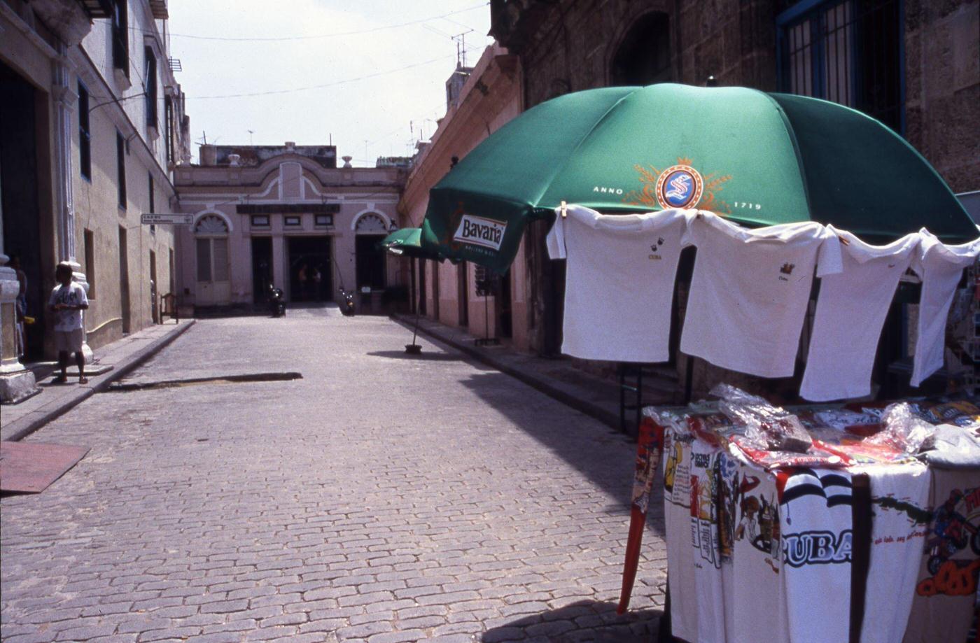 T-shirts for sale under an umbrella at a market in Havana, Cuba, June 1999.