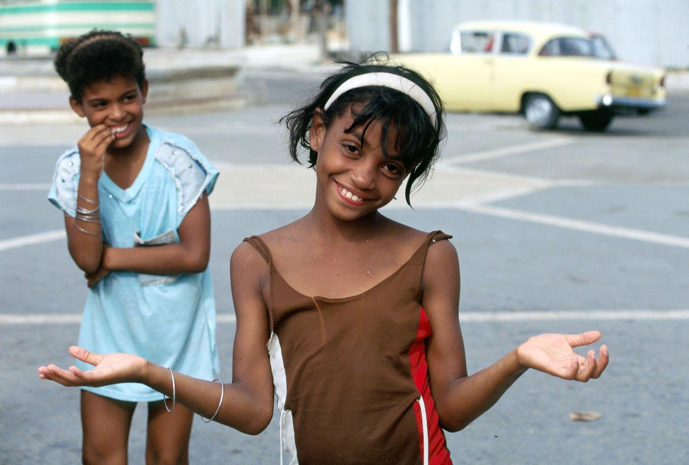 Amused Cuban little girl posing in the street in Havana, Cuba, 1990.