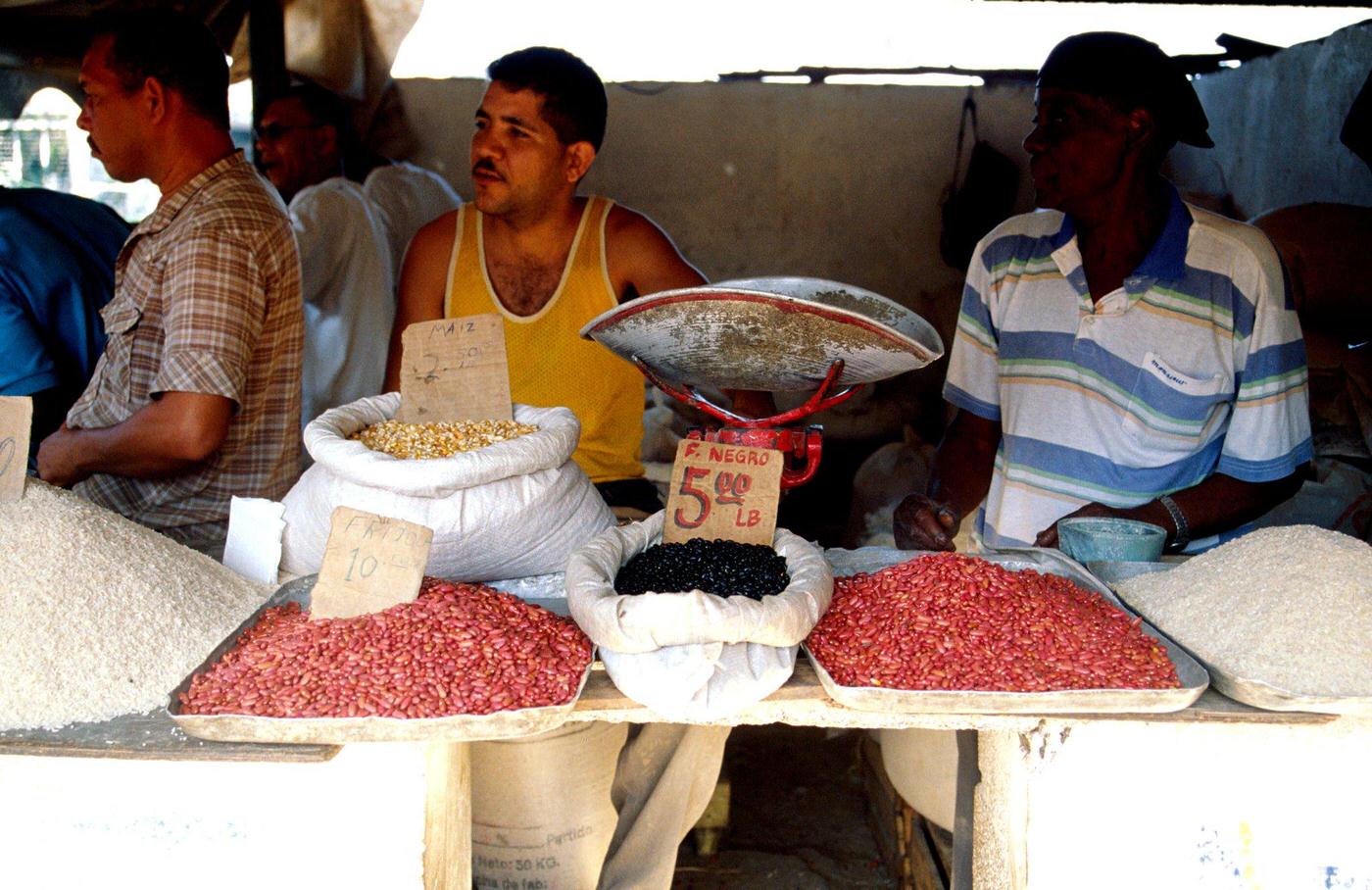 Food market in Santiago de Cuba selling rice, corn, and black beans, 1990s.