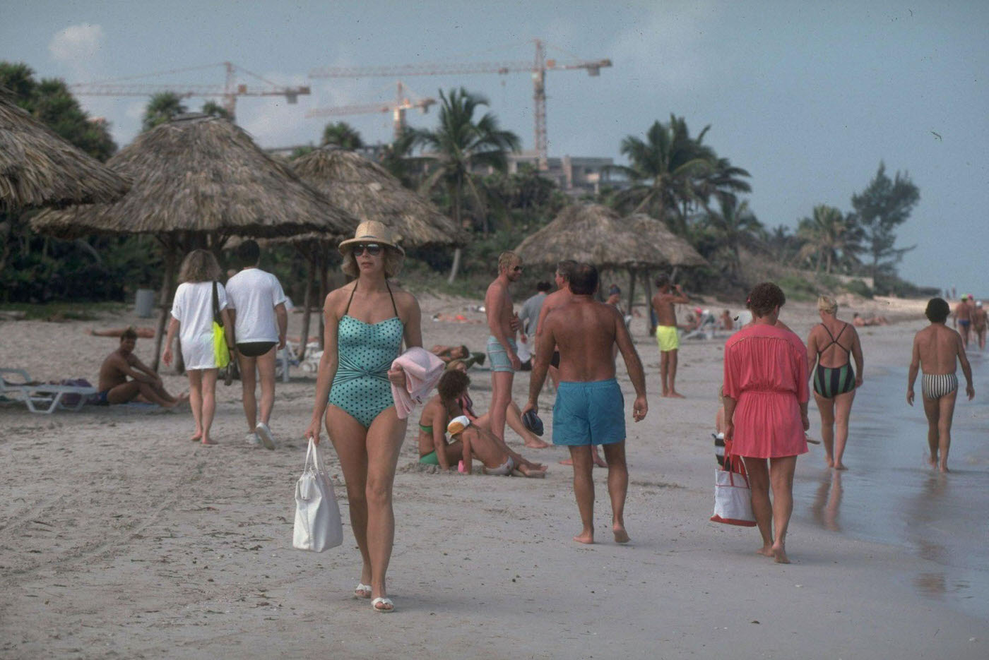 Tourists sunbathing and strolling on the beach in Varadero, Cuba.