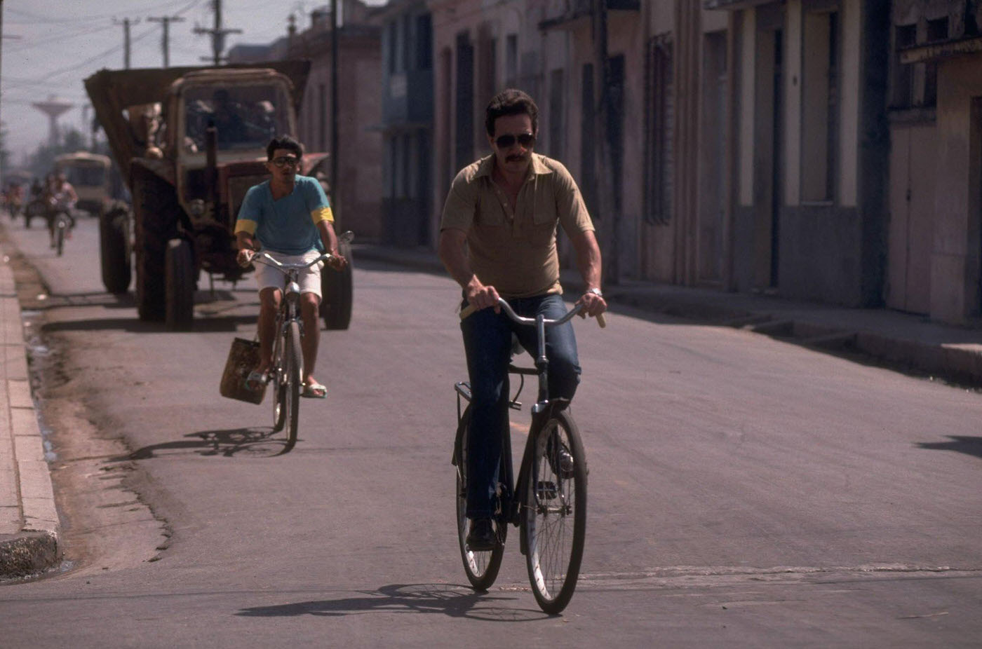 Bicyclists traversing the street, manifesting an increase in bike riding to conserve gasoline in Havana, Cuba.