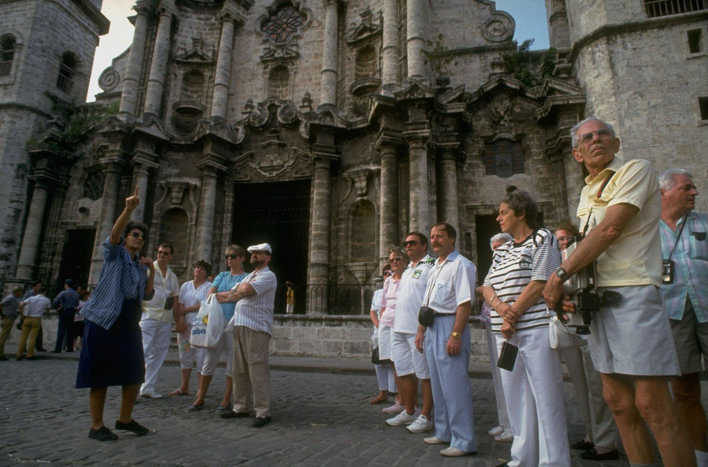 Camera-toting tour group seeing sights in the colonial section of Old Havana.