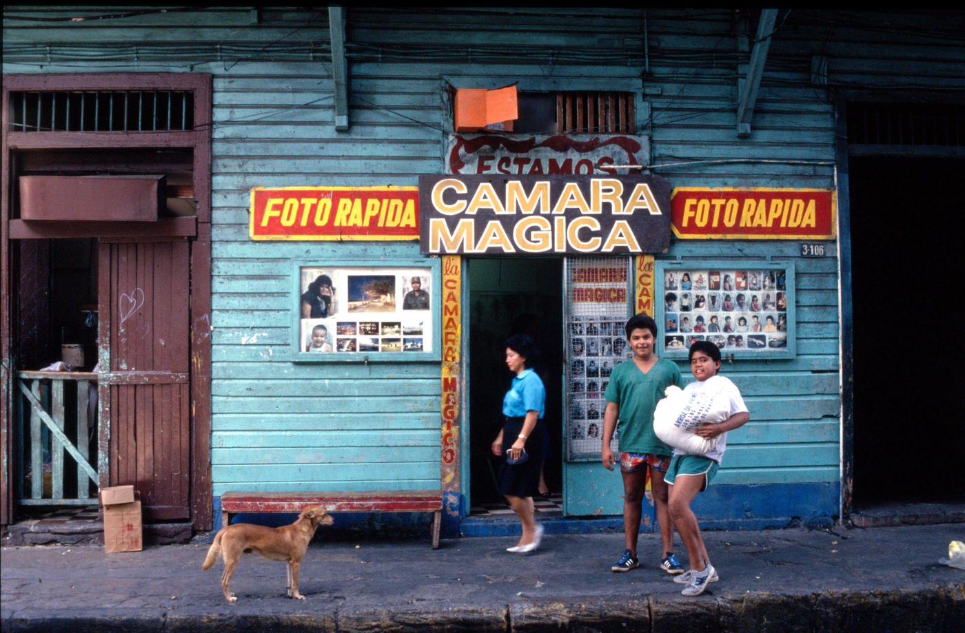 Locals standing outside a photo shop in downtown Havana, Cuba, 1991.