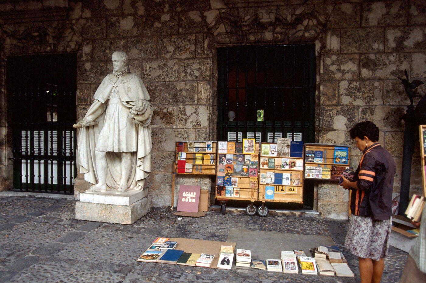 Cuban woman selling second-hand books in Havana, Cuba, 1990.