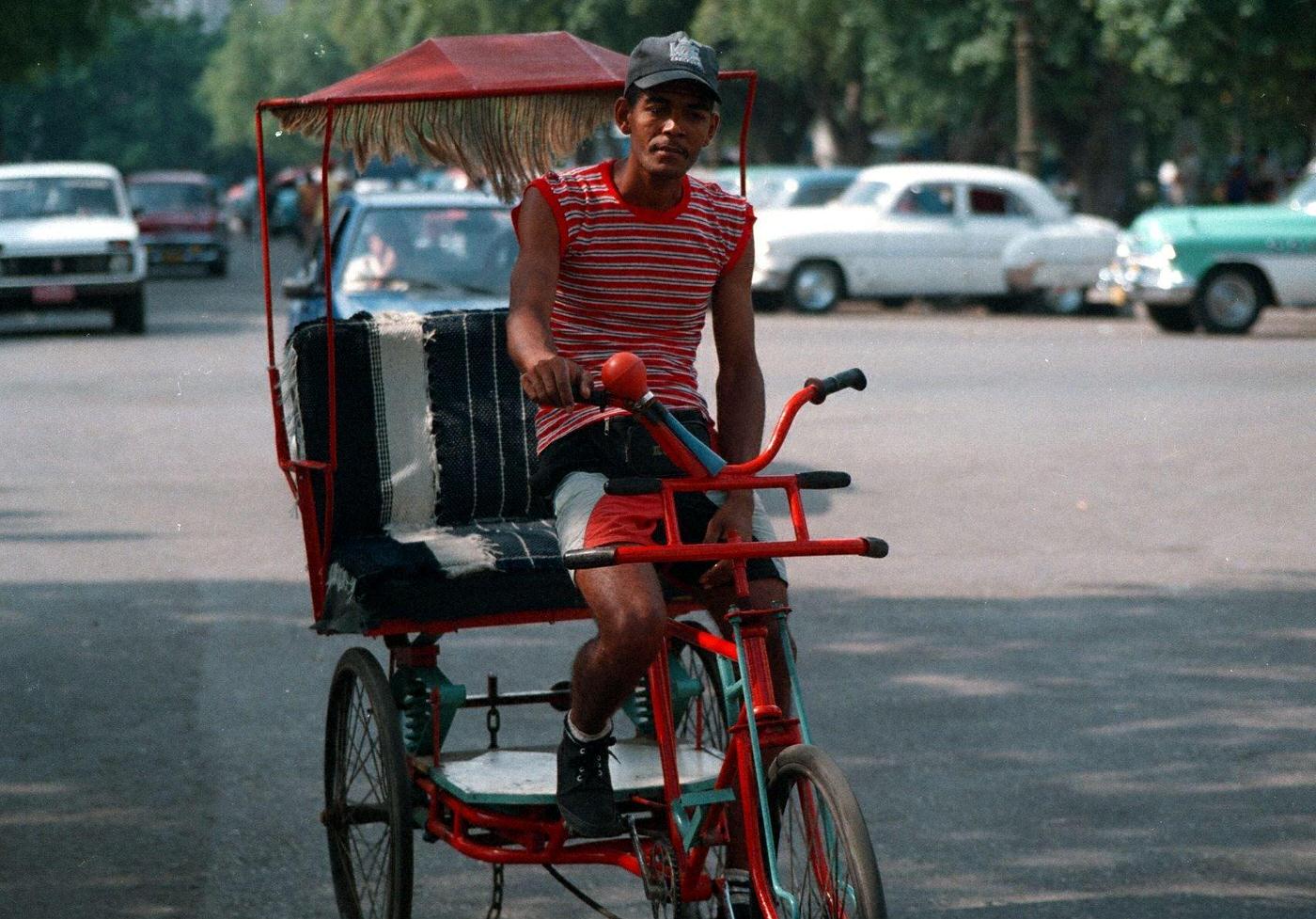 Local on a bicycle rickshaw in Havana, Cuba.