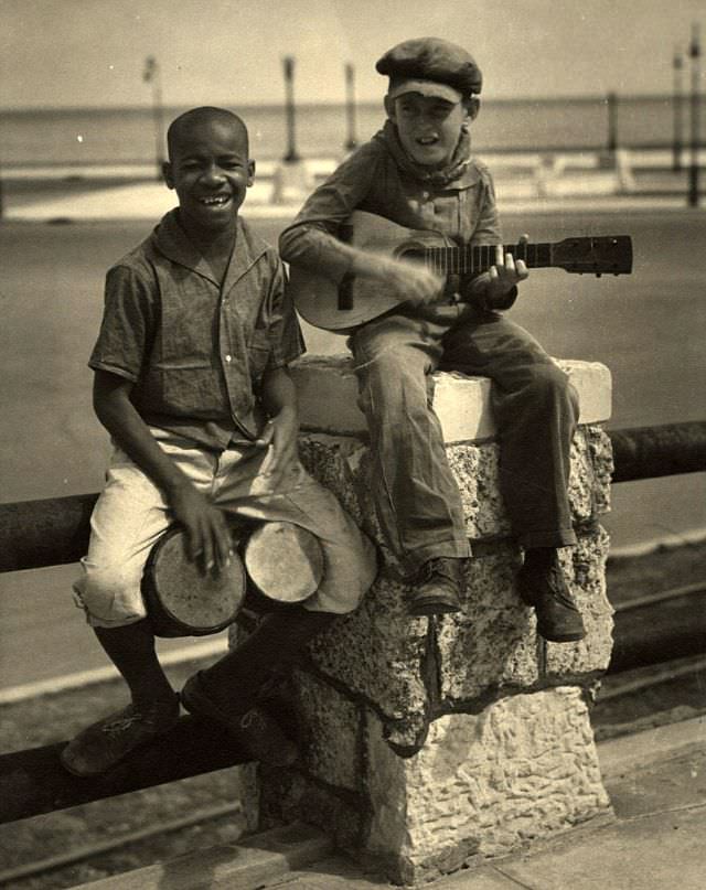 Two boys playing instruments, Cuba, 1933