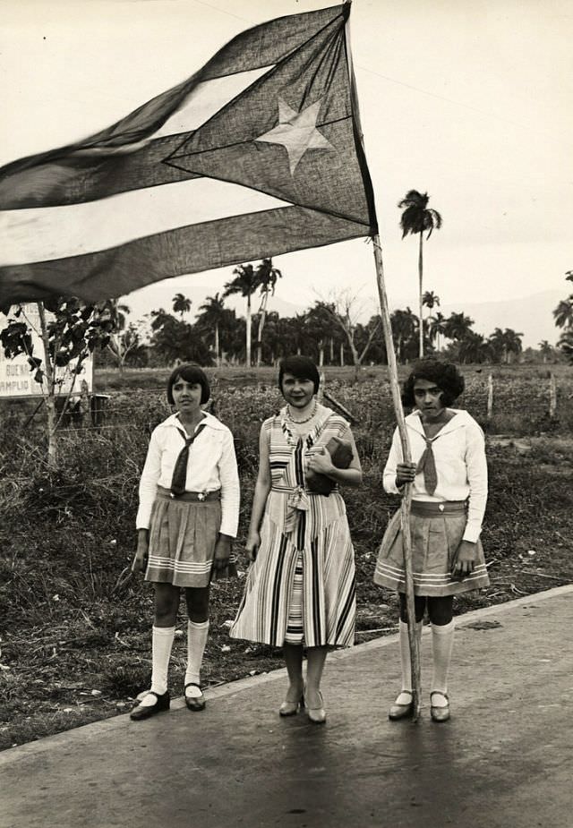 School teacher with students and flag, Cuba, 1933