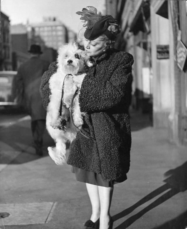 This Maltese poodle/wire-haired terrier mix called Pooch was cuddled by its owner, former Metropolitan Opera singer Thalia Sabaneev, New York City, 1944.