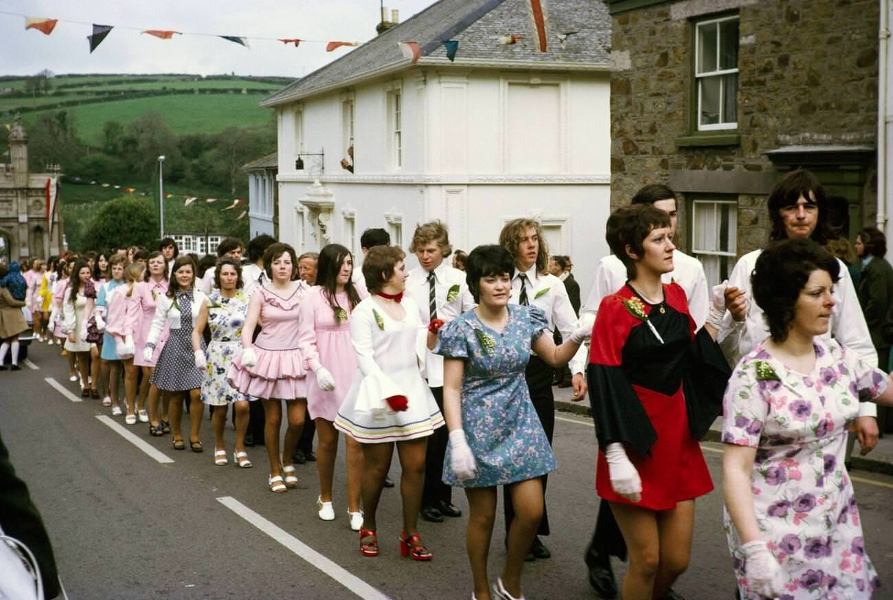 Couples walk hand in hand in procession for the Evening Dance, Flora Day