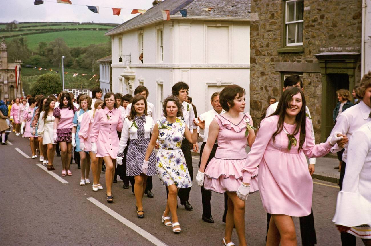 Couples walk hand in hand in procession for the Evening Dance, Flora Day