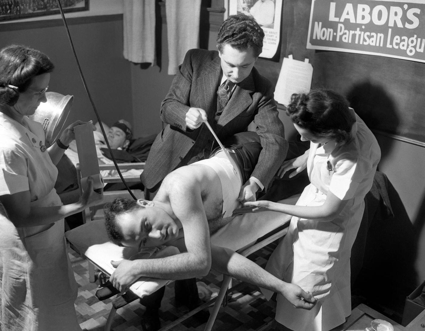 A man has his side taped after being injured in the riots during the Ford Motor Company strike at the River Rouge Plant in Dearborn, Michigan, April 9, 1941