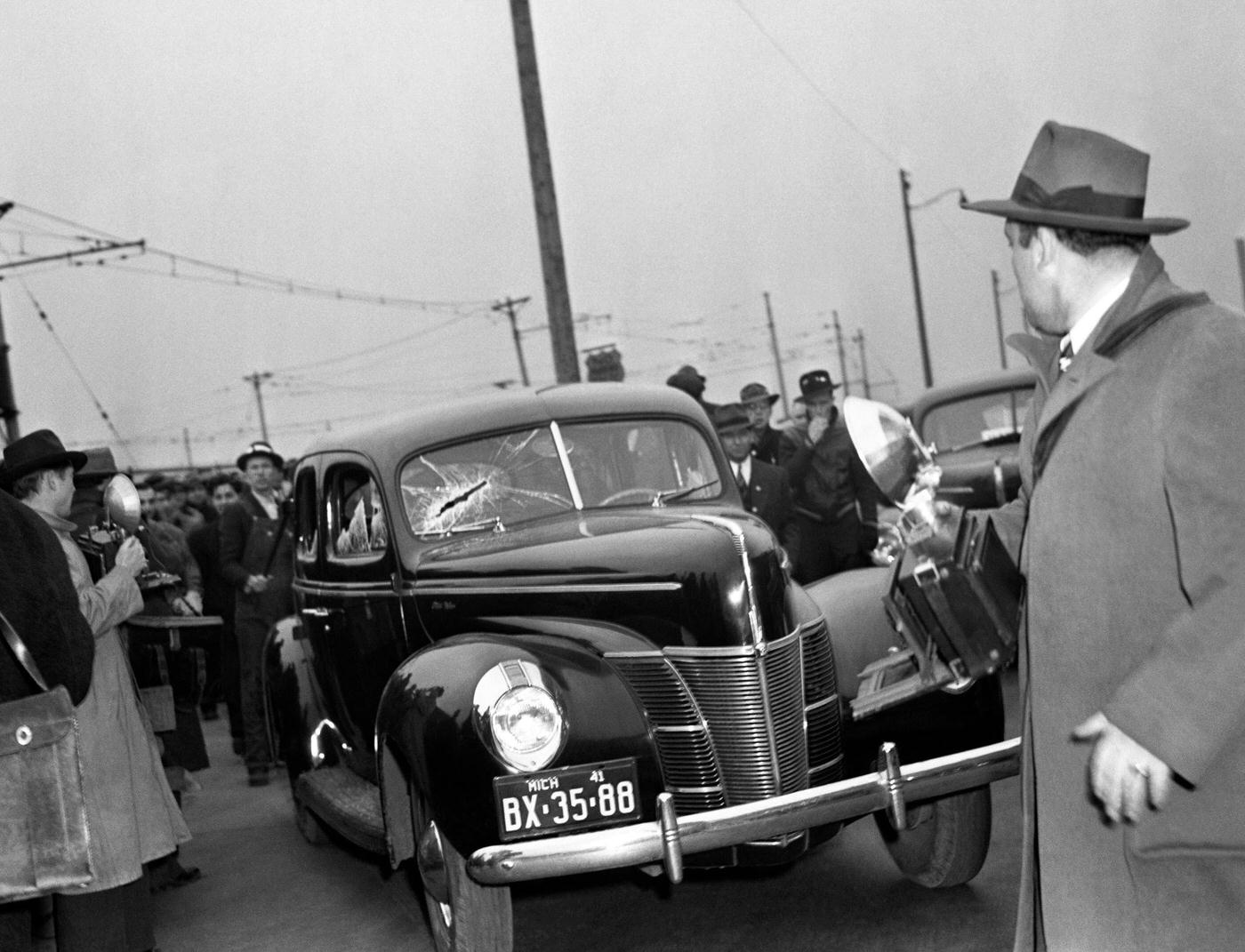 A non striker was taken into custody by state police here, after he and a companion swung at picketers who stopped their car and broke windows in Dearborn, Michigan, April 11, 1941.