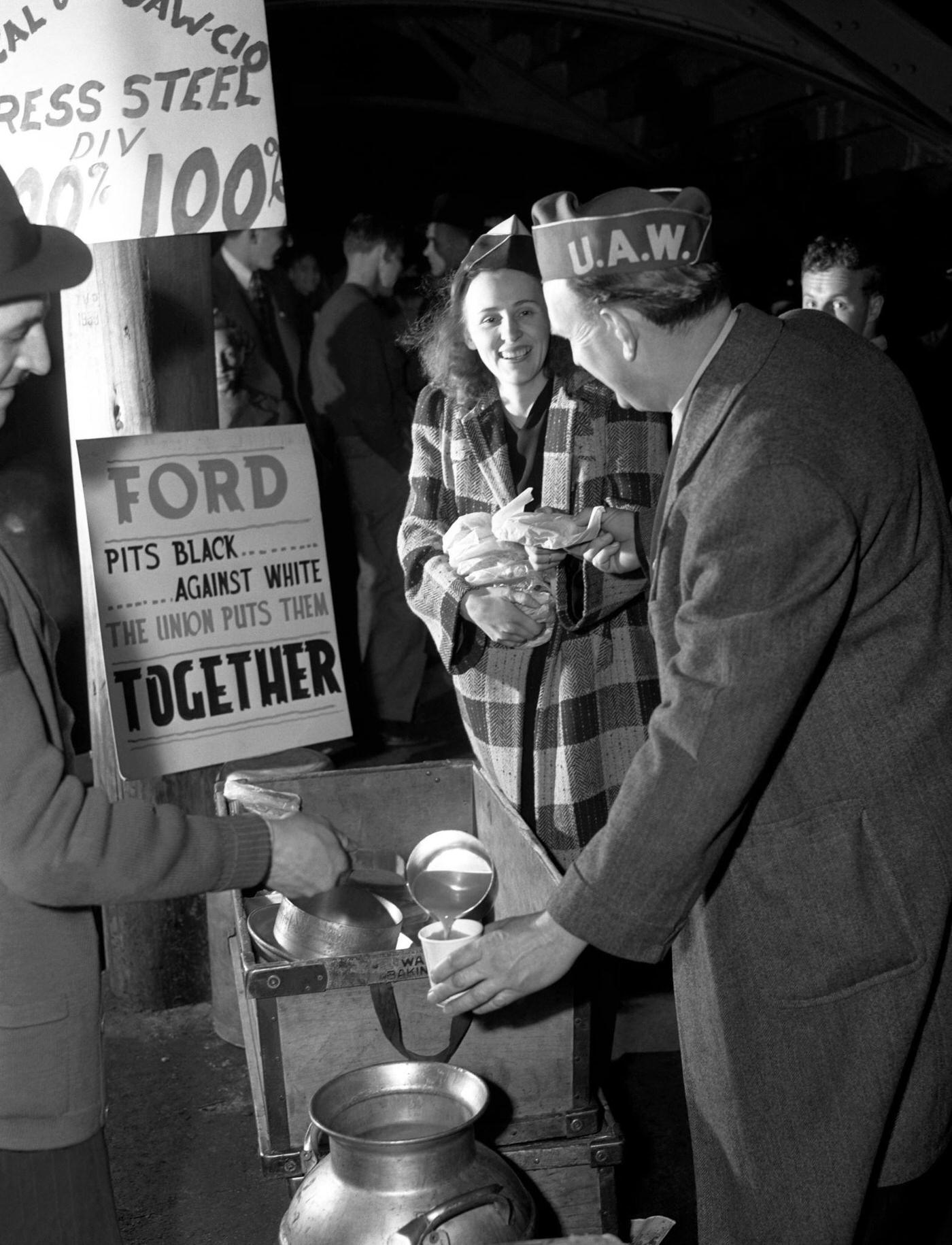 Two United Auto Workers (UAW) get coffee and food during the Detroit Ford Motor Company strike near the Ford River Rouge complex in Dearborn, Michigan, April 1941.