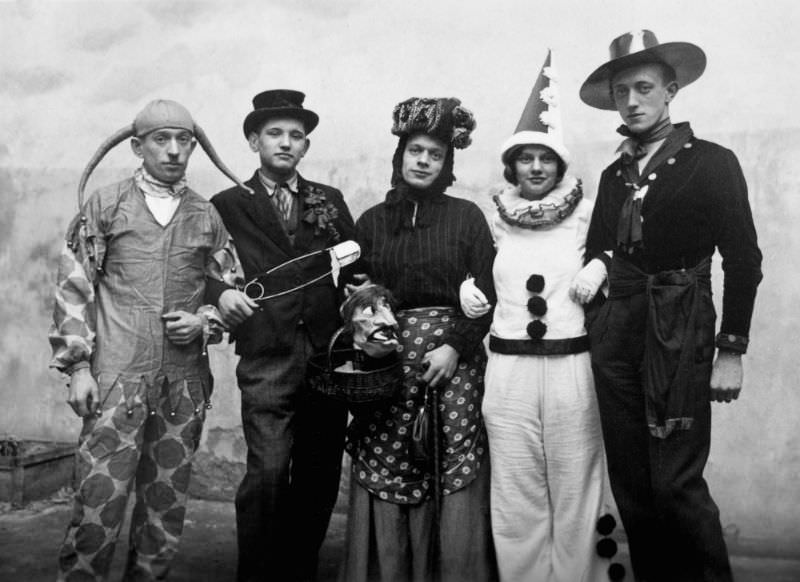 Early 20th-century partygoers pose for a Halloween photo.