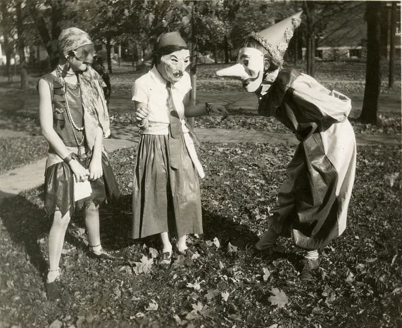 Three girls wearing masked costumes in Cincinnati, Ohio, 1929.