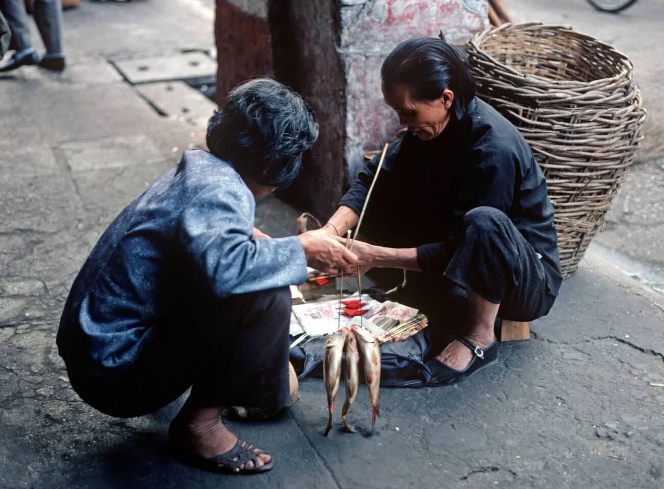 Customer with recently bought fish in street market, Guangzhou, China