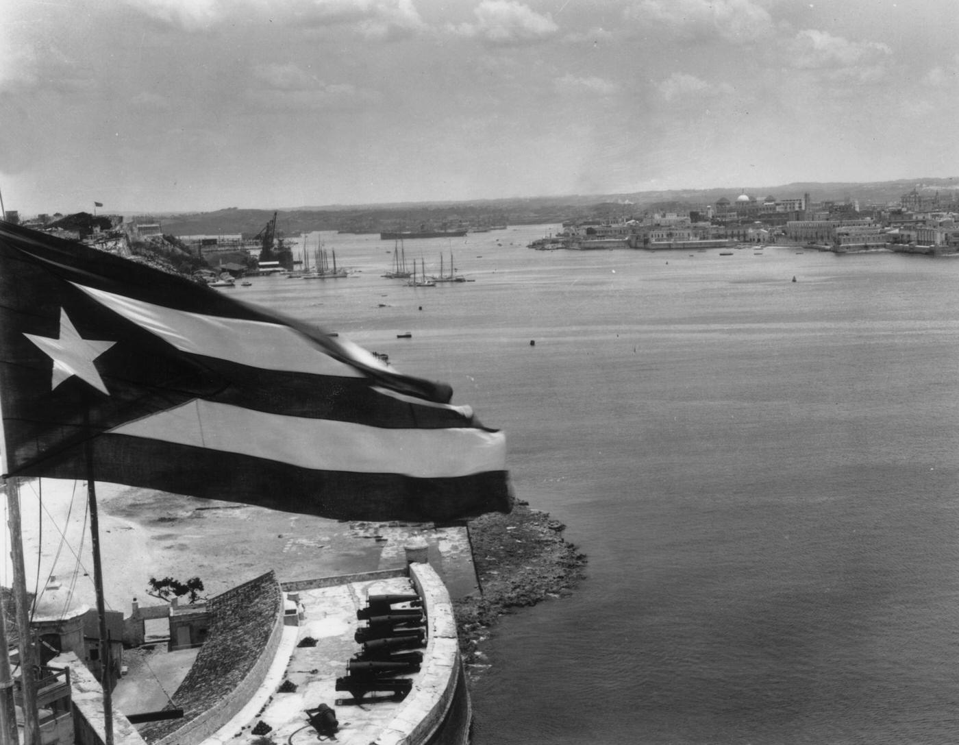 Cuban flag flying above the chief port and capital, Havana, 1934