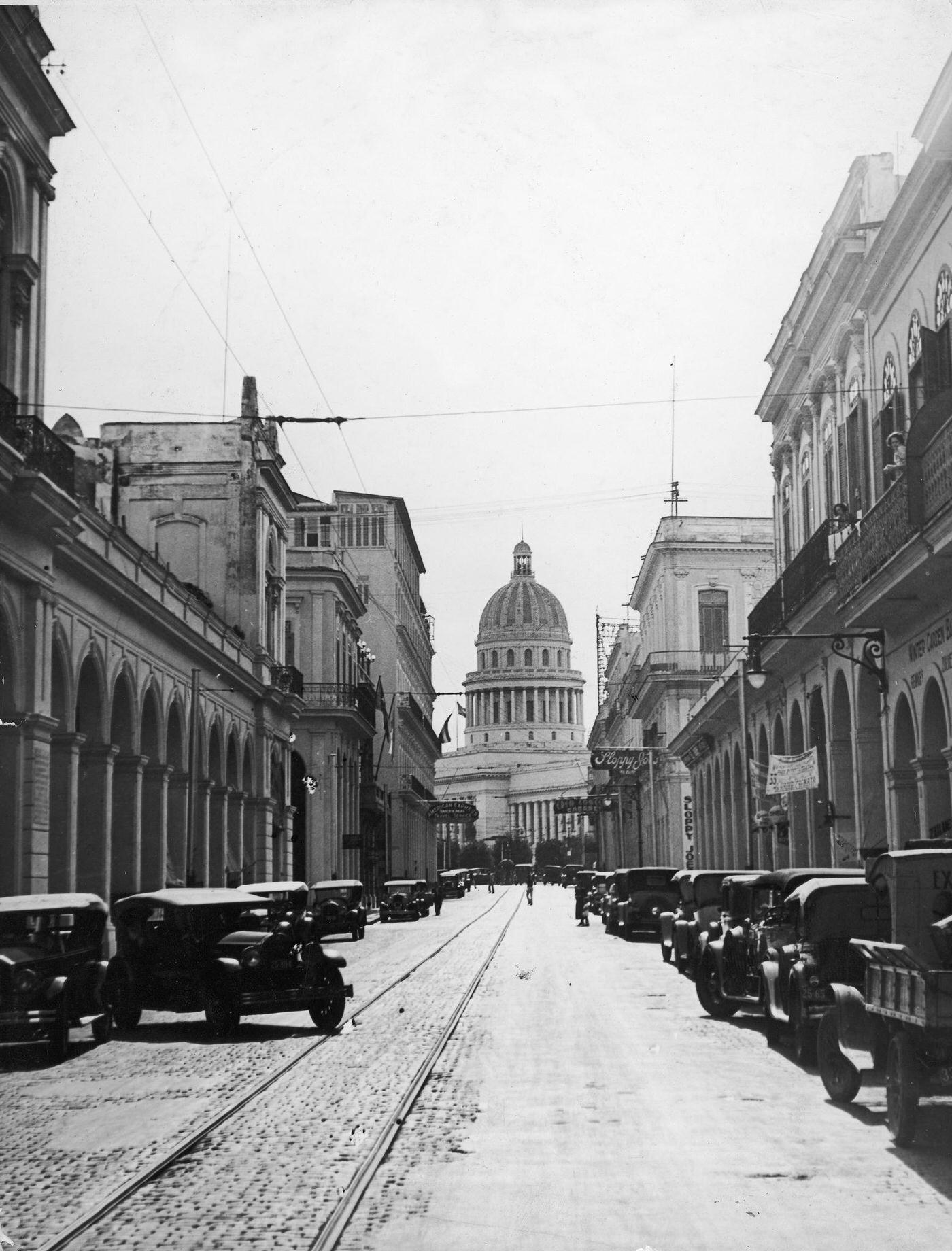 View of cars parked on Calle Zulueta with the Capitol building in the background, Havana, Cuba, 1935