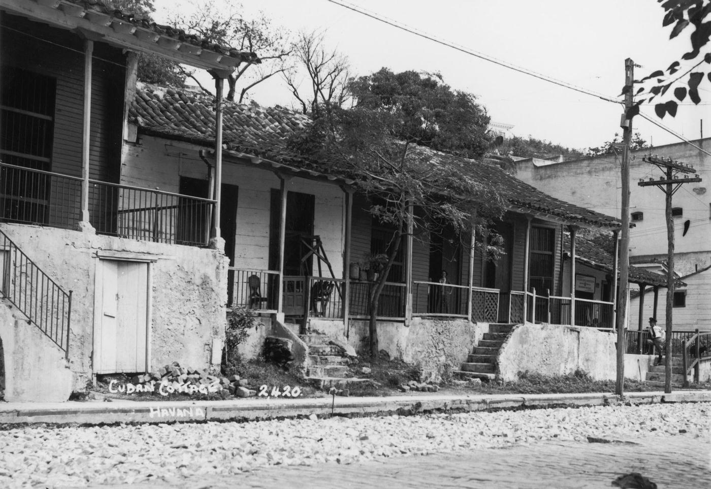 Run-down, single-storey houses on a street in Havana, capital of Cuba, 1938