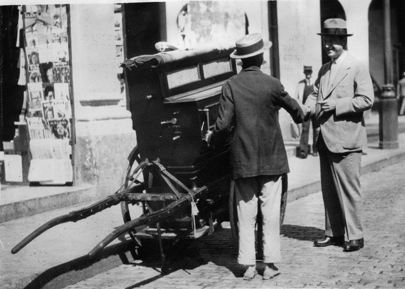 Cognac producer Paul Martell with a street musician in Havana, 1930