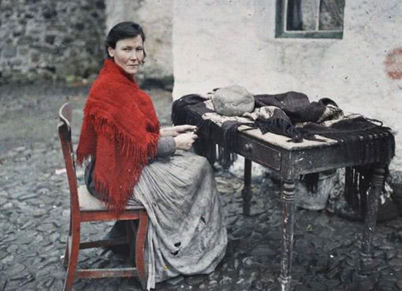 Hardworking mother of seven skillfully making fringes for a knitted shawl in Galway, 29 May 1913