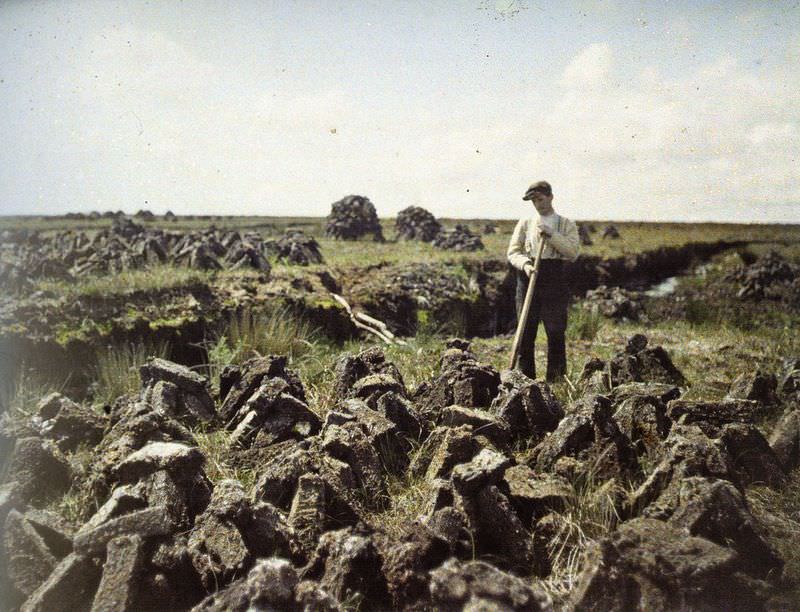 A man diligently cutting turf in the picturesque landscapes of South Connemara, 29 May 1913