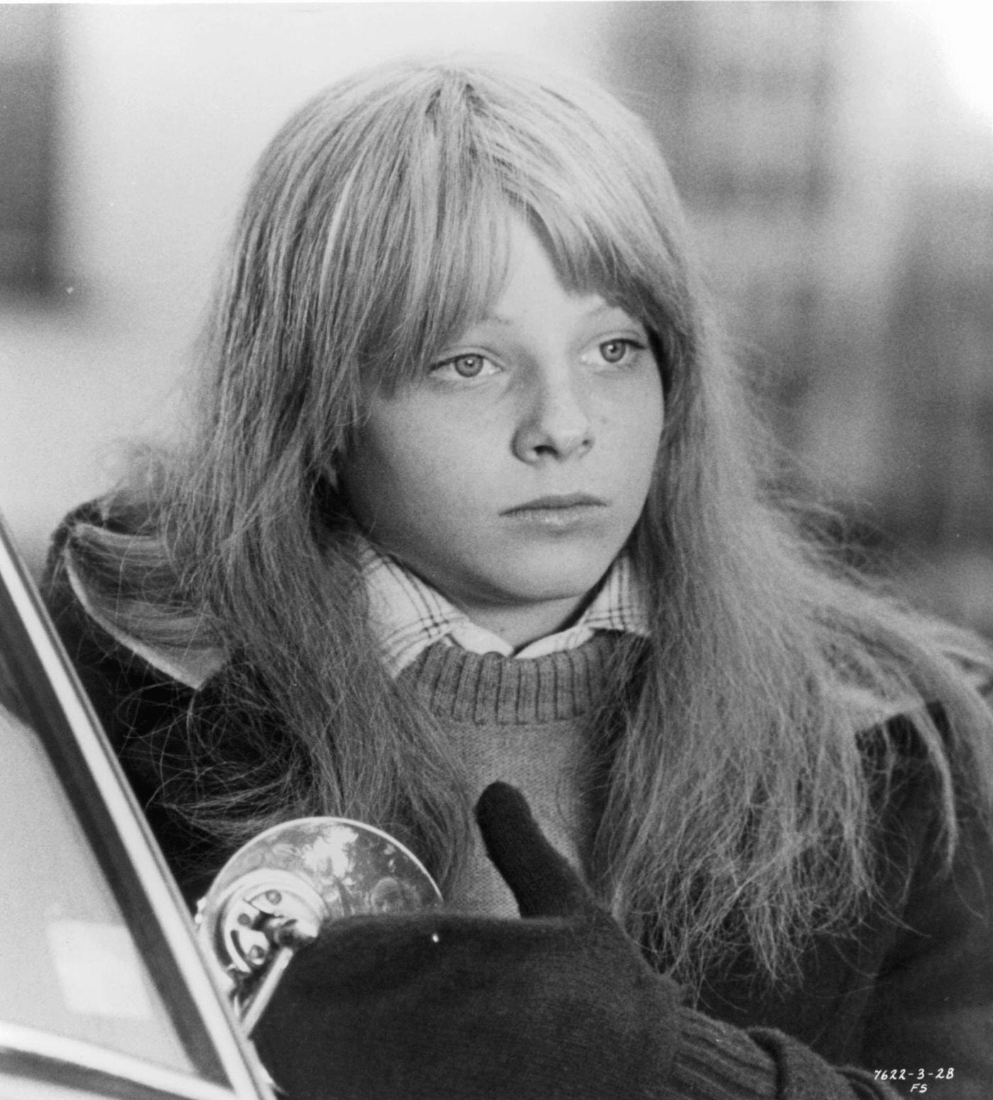 Jodie Foster standing beside a car in 'The Little Girl Who Lives Down The Lane', 1976.