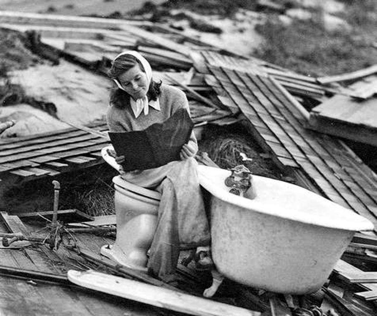 Katharine Hepburn searching through the debris of her Fenwick home after the Hurricane of 1938.