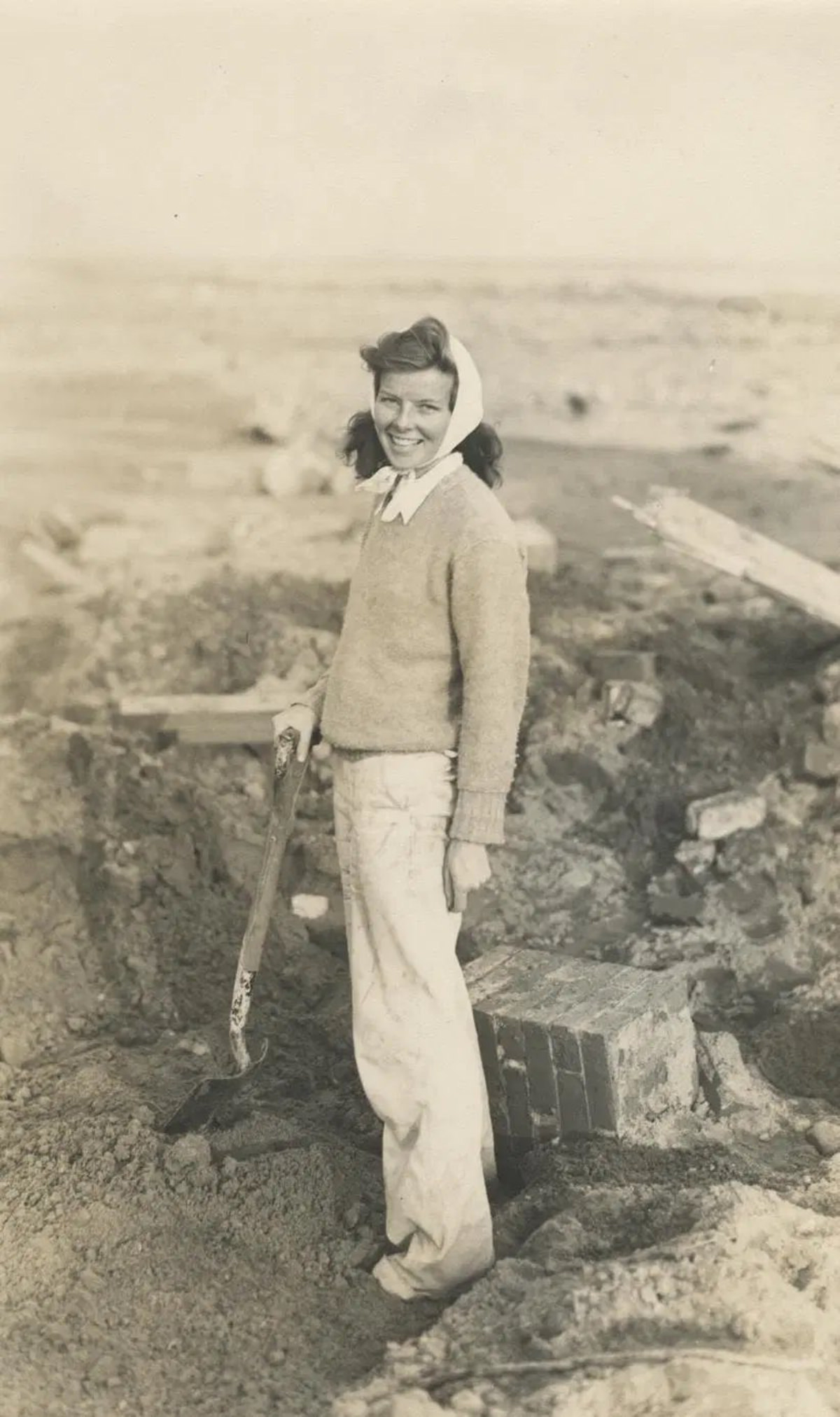 Hepburn searching through debris of her family’s summer cottage after the hurricane of 1938.