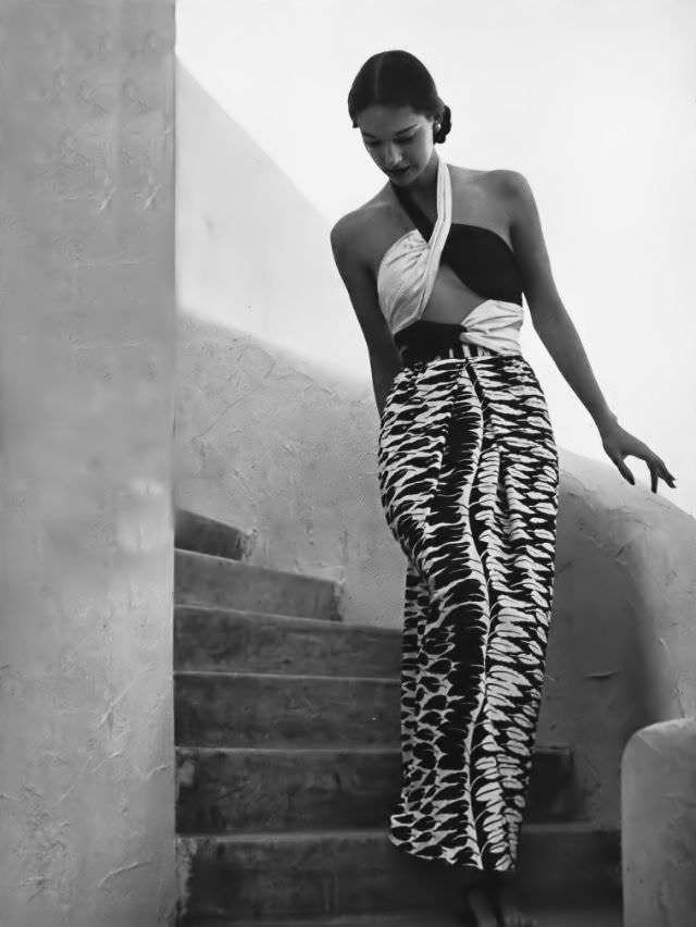 Marilyn Ambrose in a cabana dress of black and white rayon jersey, the printed leaves have sequins along the spines, Vogue, 1945.