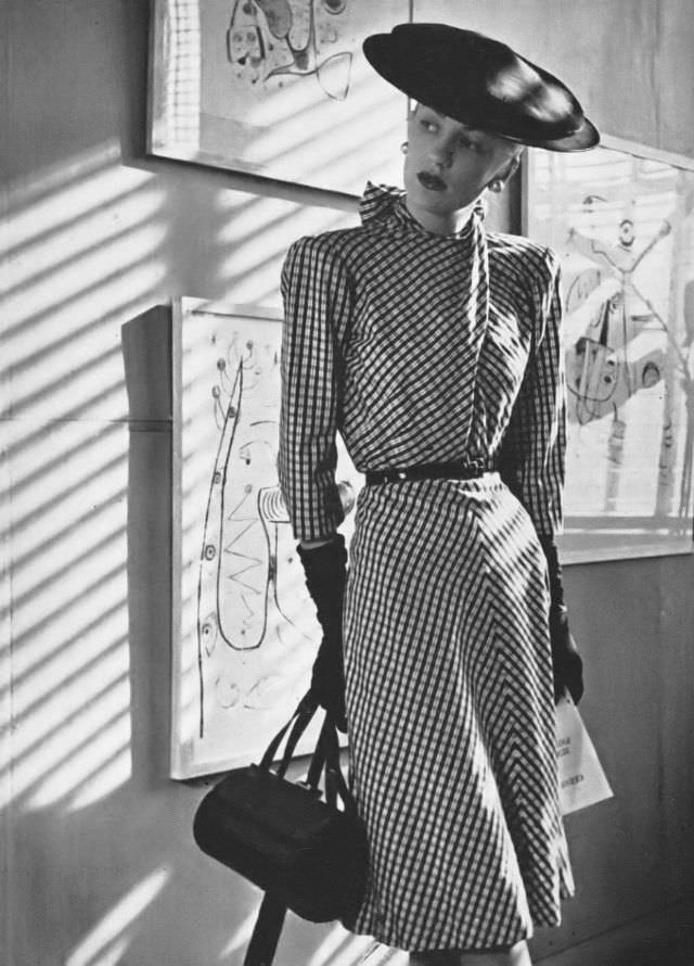 Model in black-and-white cotton taffeta dress with a back-tied neck by Troy Guild, at the Joan Miró exhibition, Vogue, 1945.