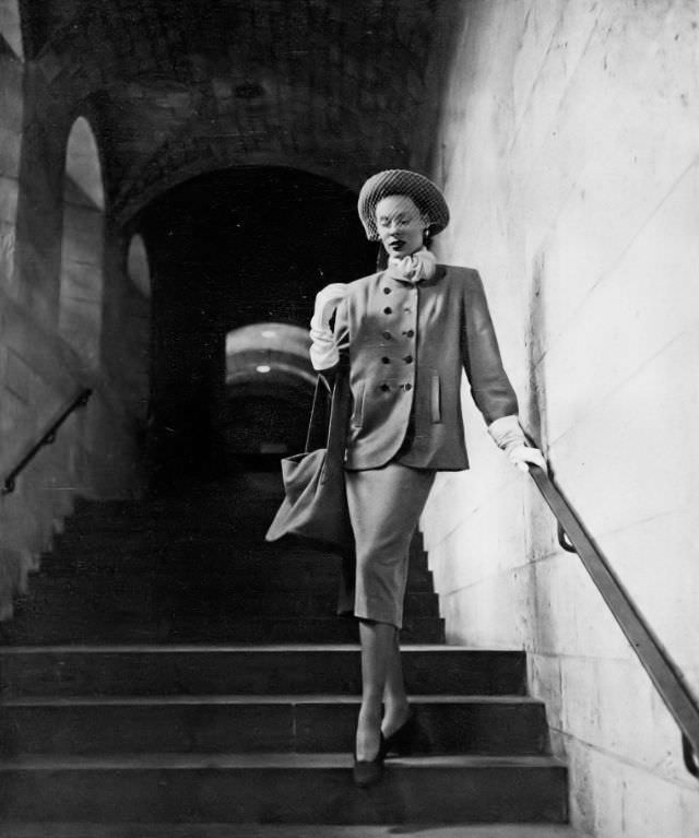 Meg Mundy in brass-buttoned box jacket, Vogue, 1947.