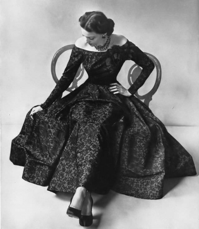 Model in black Chantilly lace filigreed on rayon taffeta in this gown with a very full skirt by Ben Reig for Saks Fifth Avenue, Vogue, 1947.