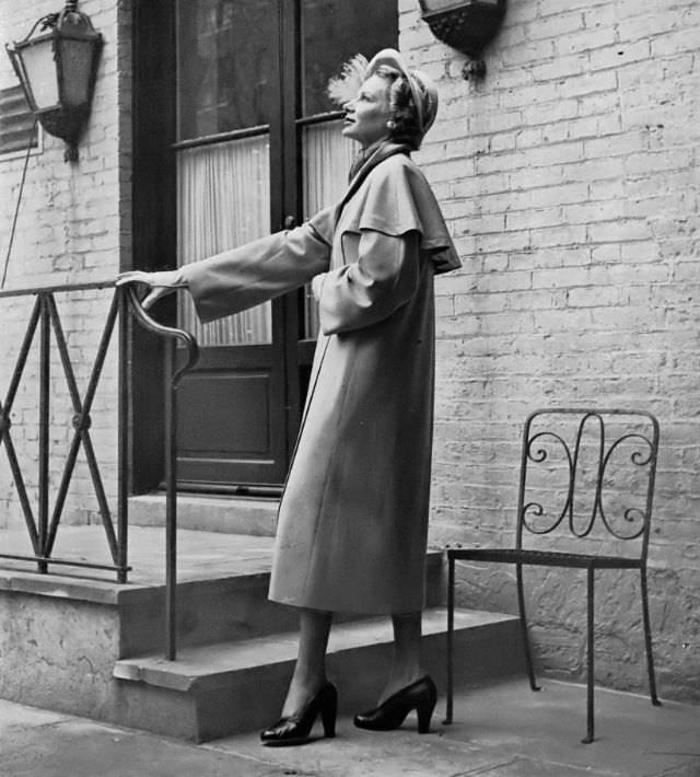 Joan Pedersen in Miron gabardine coat with capelet by George Carmel at Saks Fifth Avenue, Harper's Bazaar, 1948.