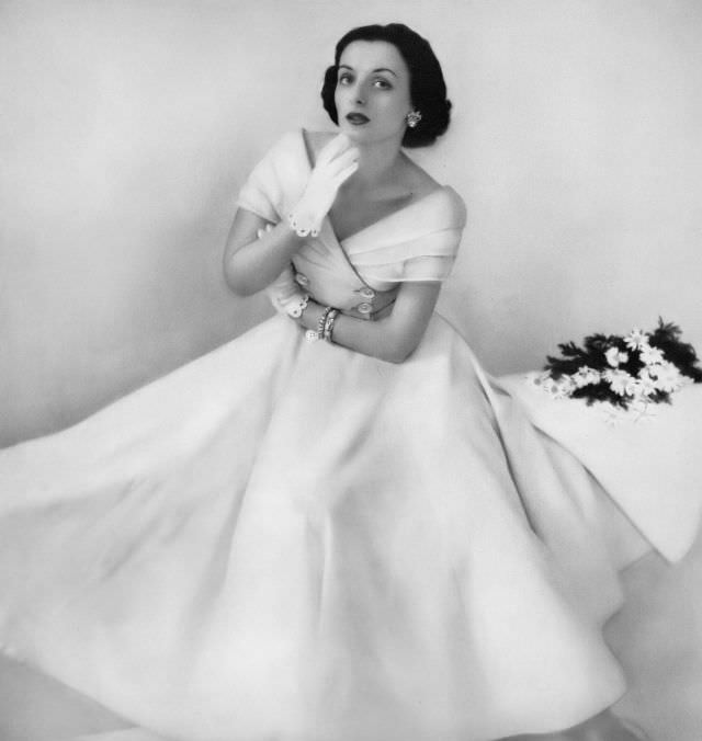 Lucille Lewis in lovely party dress of white piqué, double breasted with triple shawl collar of organdy by Herbert Sondheim, Harper's Bazaar, 1948.