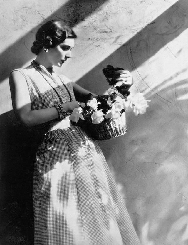 Model in charming dress of red and white checked sheer cotton by Nelly Don, Harper's Bazaar, 1948.