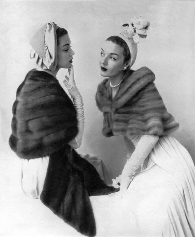 Jean Patchett in Royal Pastel mink stole and model in Silver Blue mink mantlet with convertible shoulder-cuff by Bergdorf Goodman, Vogue, 1949.