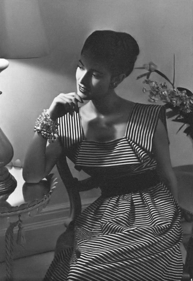 Model in a pink-and-black striped piqué party dress by Capri, Vogue, 1945.