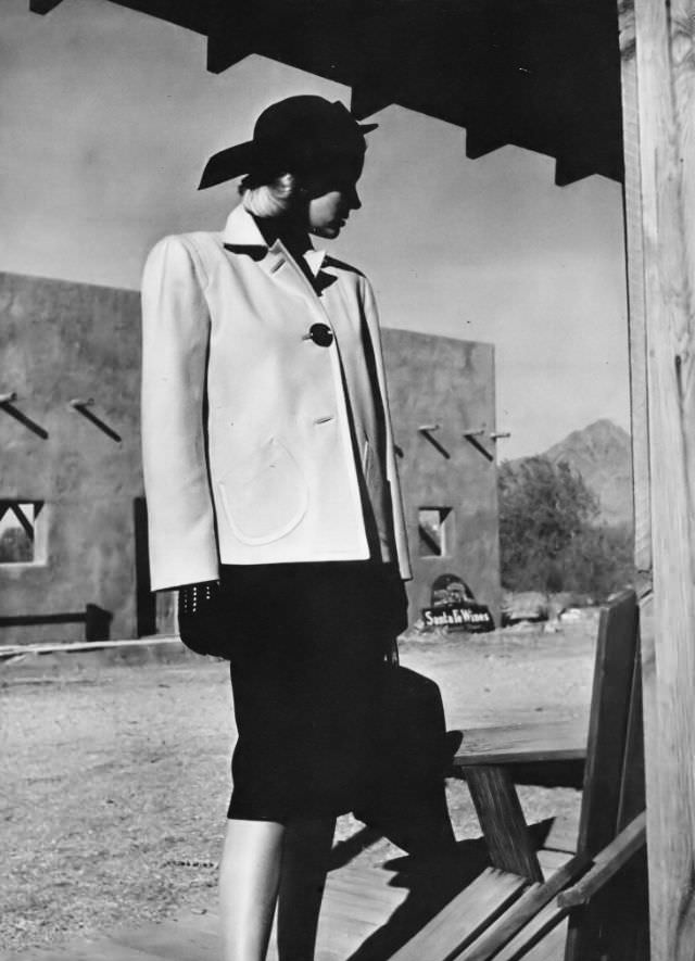 Model in a short sand-beige coat of wool velour by Duchess Royal, Camelback Mountain, Arizona, Vogue, 1945.