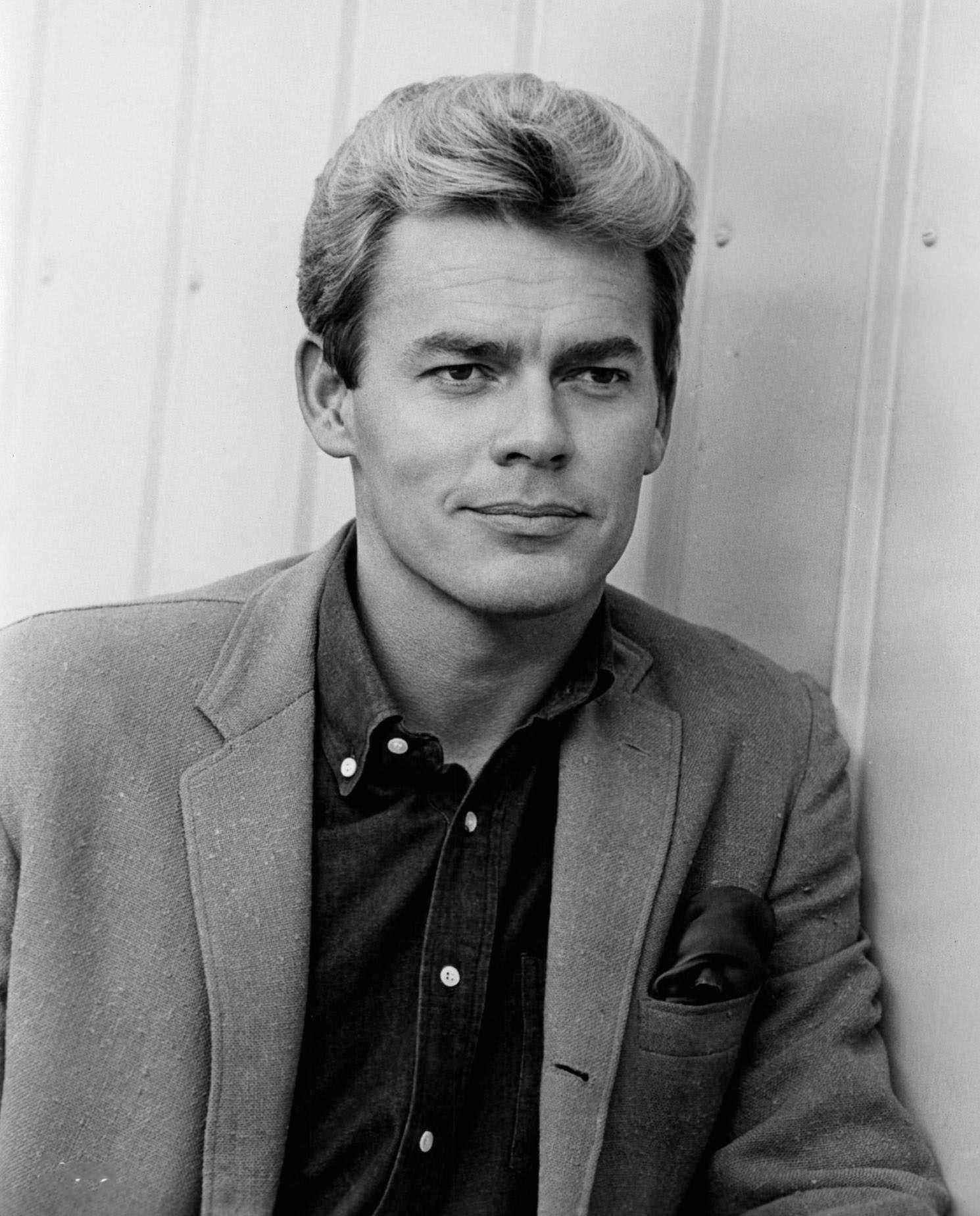 James Ward standing near wall in a scene from the film 'Kitten With A Whip', 1964
