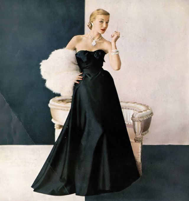 Liz Pringle in satin faille and Enka rayon evening gown by Maurice Rentner, fox fur by Fredrica, jewlery by Kramer, October 1951