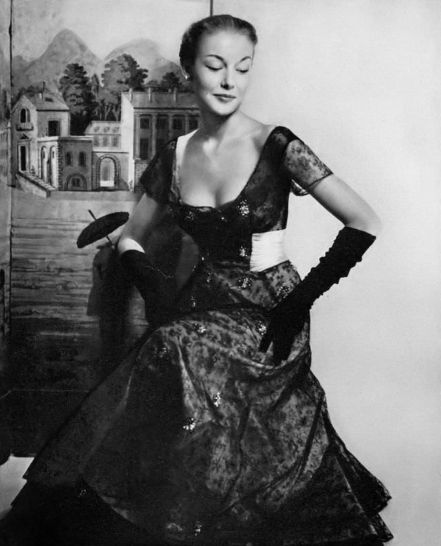 Liz Pringle in pink silk taffeta with a delicate tracery of black lace embroidered with clusters of rhinestones, the waist is bound with a wide pink satin sash, Harper's Bazaar, October 1948