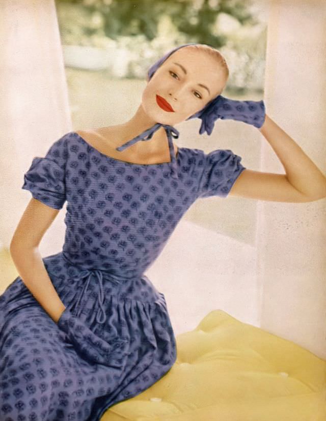 Liz Pringle in violet floral silk surah print sheath with floating shirred apron by Adele Simpson, April 1955