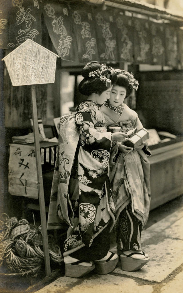 Two young girls on a street in the 1910s