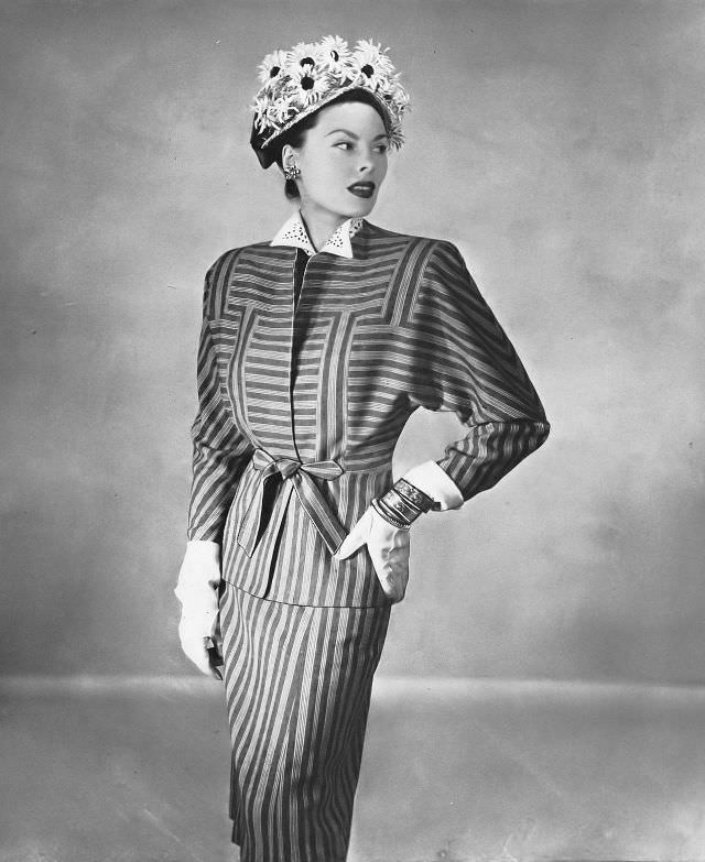 Meg Mundy in Miron's worsted suit of pink-on-black stripes or beige-on-brown at Russeks, Harper's Bazaar, February 1946